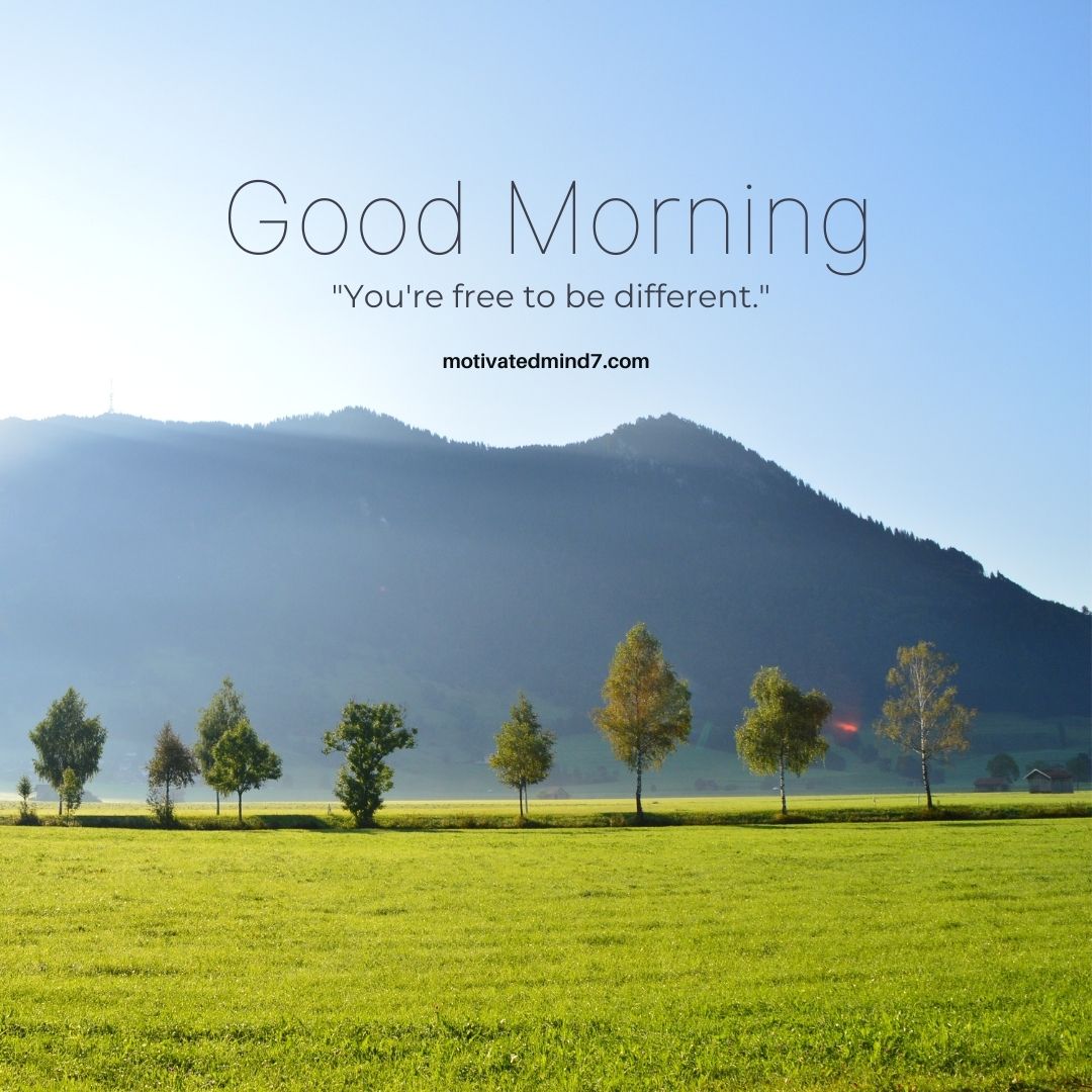 a serene landscape with a green field in the foreground, a row of trees, and a mountain range in the background under a clear blue sky.