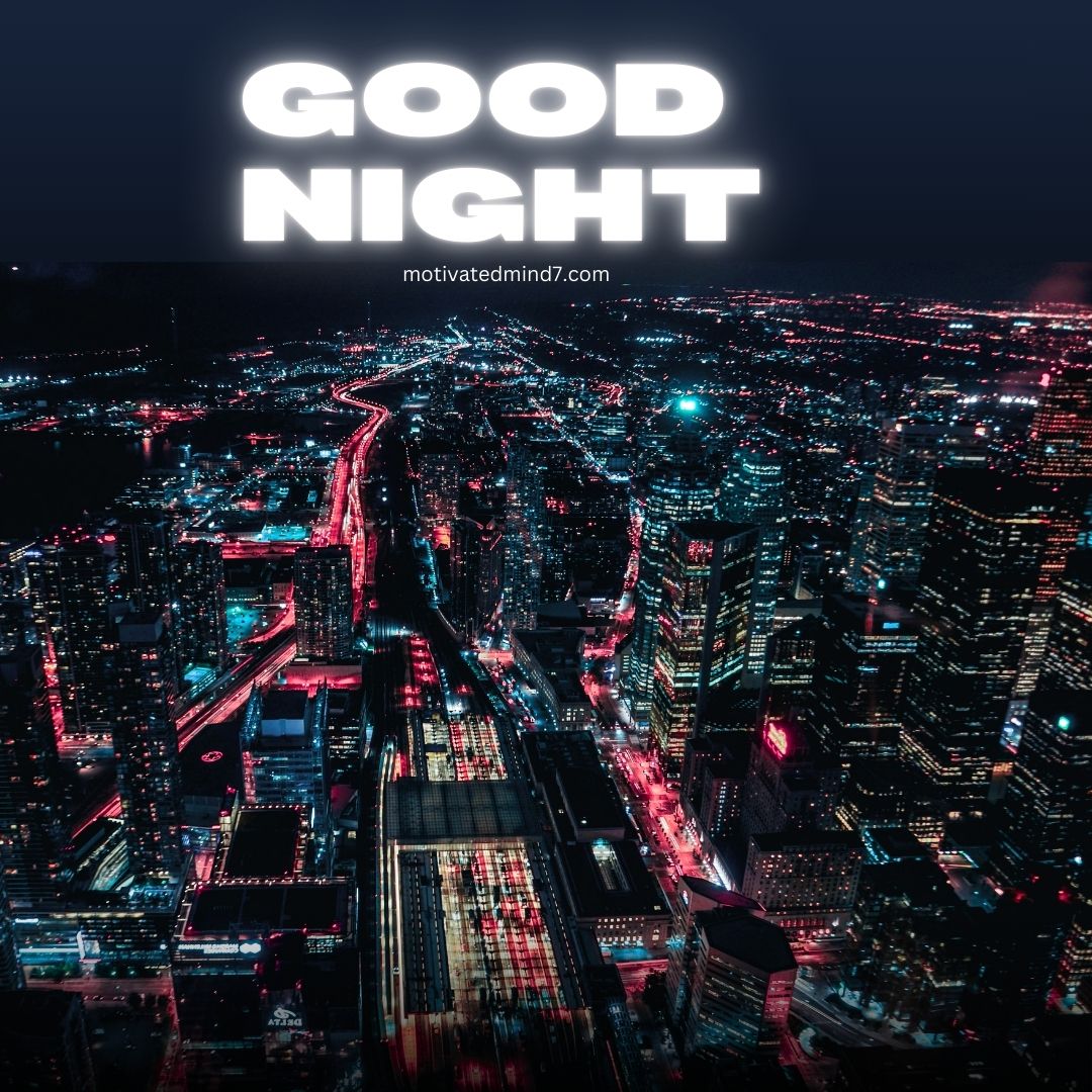 Nighttime aerial view of a bustling city, with numerous buildings and streets illuminated by streetlights and building lights. The vibrant scene features a mix of red, blue, and white lights. This image beautifully captures the lively atmosphere of a city at night, showcasing the contrast between the dark sky and the bright city lights.